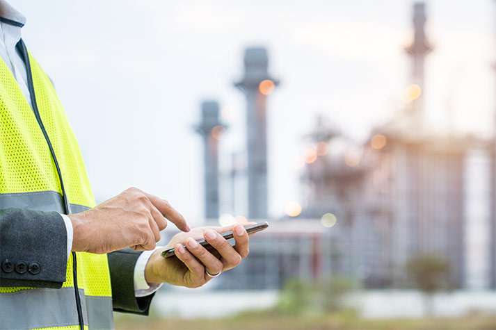 Worker using cell phone at worksite