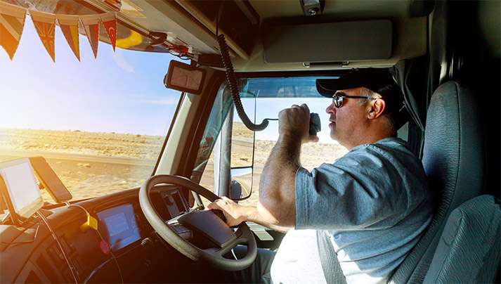 Trucker using hand-held radio while driving